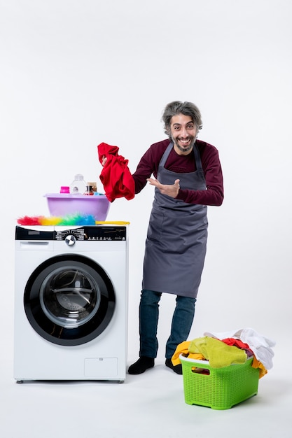 Front View Housekeeper Man Holding Laundry Standing Near Washing Machine On White Isolated Background