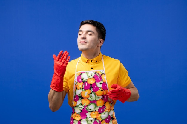 Front view housekeeper man smelling something on blue space