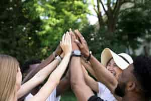 Free photo front view interracial friends cheering