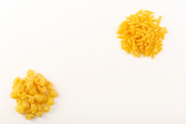 A front view italian dry pasta raw yellow pasta collection lined on the white background food meal italian