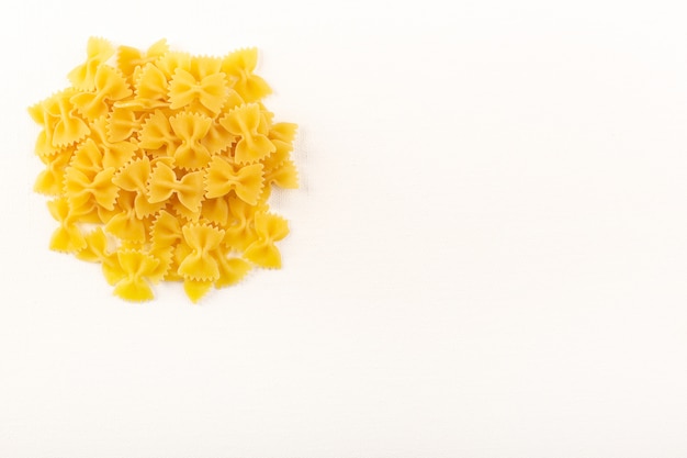 A front view italian dry pasta raw yellow pasta lined on the white background food meal italian