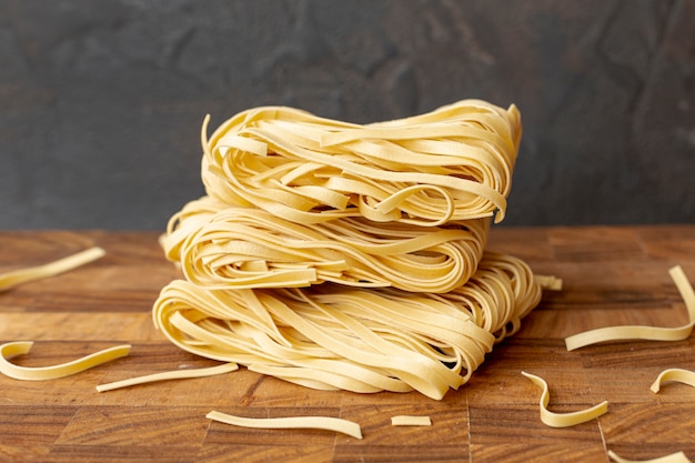 Front view of italian pasta on wooden table