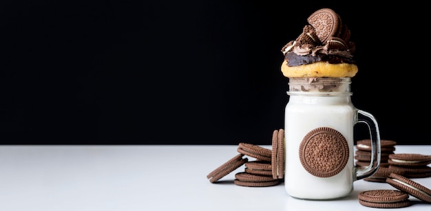 Free photo front view of jar of dessert with biscuits and donut