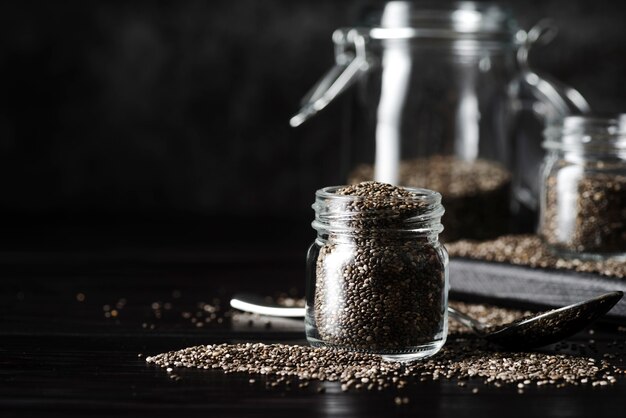 Front view jar filled with organic seeds and shadows