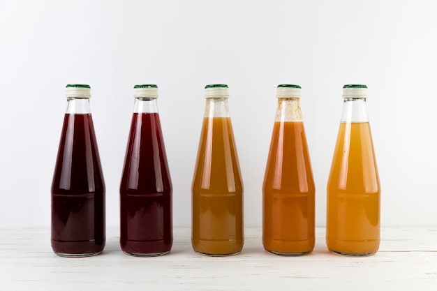 Front view juices on table with white background