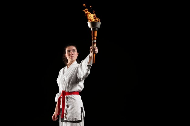 Front view of karate athlete with torch