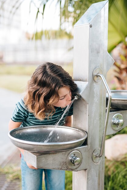 Front view of kid drinking water