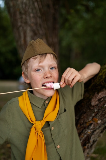 Front view kid eating marshmallows