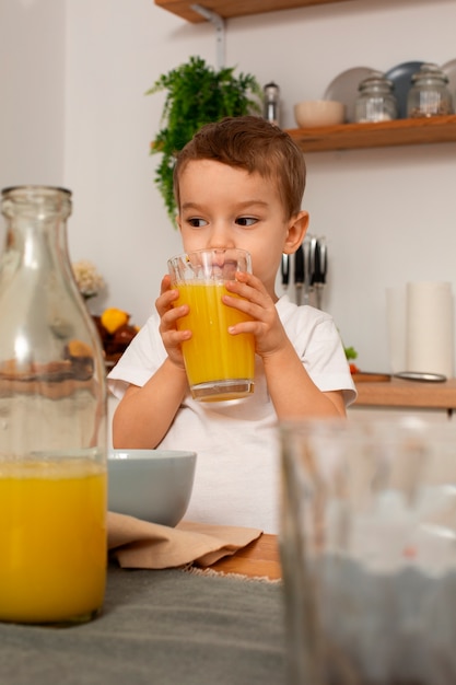 Free photo front view kid holding juice glass