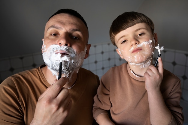 Front view kid learning how to shave