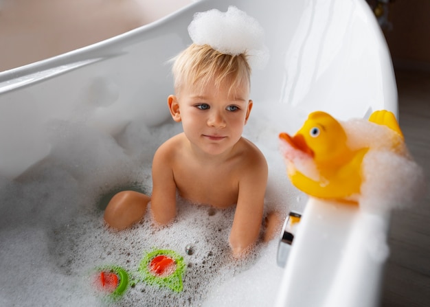Free photo front view kid playing in bathtub