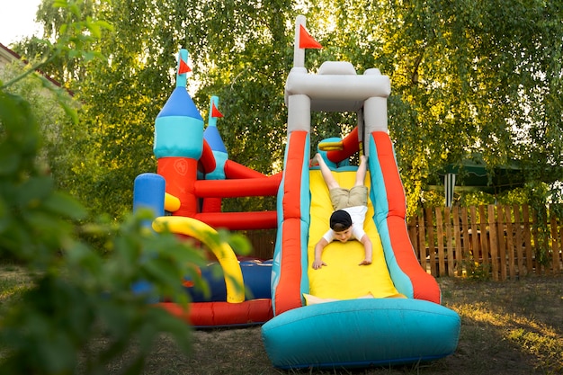 Front view kid playing in bounce house