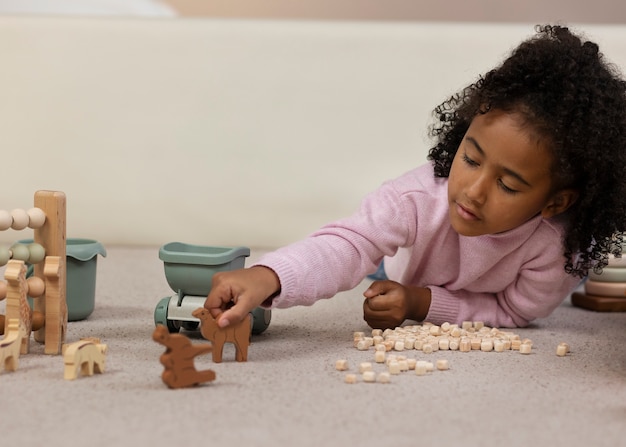 Front view kid playing with wooden pieces