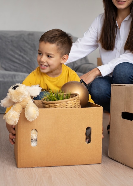 Front view kid sitting in box