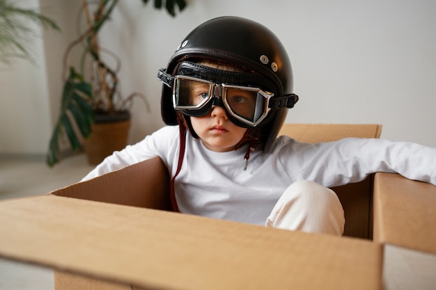 Front view kid sitting in box