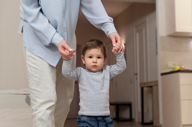 Front view kid walking at home