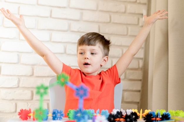 Free photo front view kid with floral toy