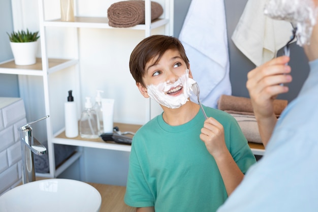 Front view kid with shaving cream