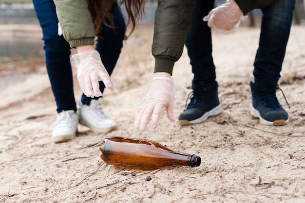 Free photo front view of kids cleaning the ground