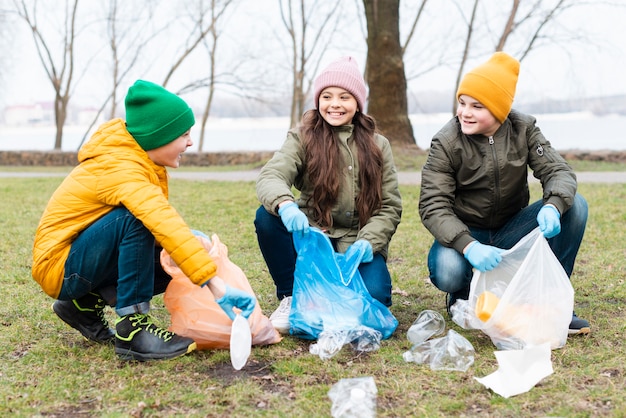 Front view of kids cleaning the ground