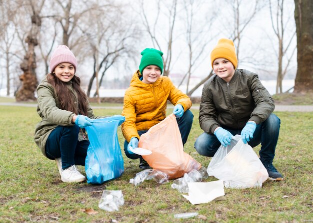 Front view of kids cleaning the ground