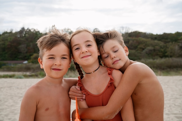 Free photo front view kids having fun at the beach