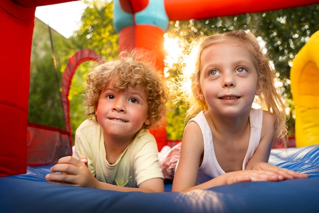 Front view kids laying in bounce house