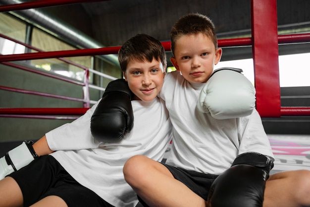 Free photo front view kids learning boxing