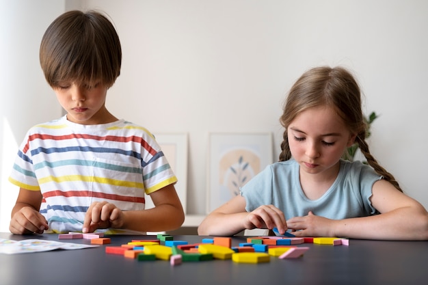 Front view kids making puzzle together