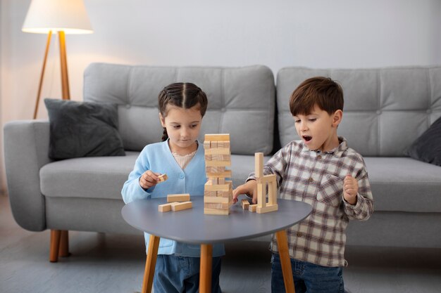 Front view kids playing at table