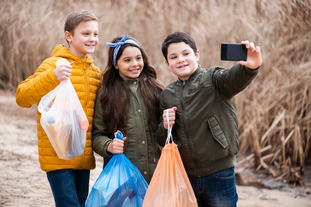 Free photo front view of kids taking a selfie