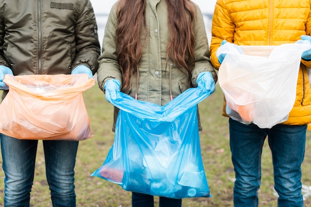 Front view of kids with plastic bags