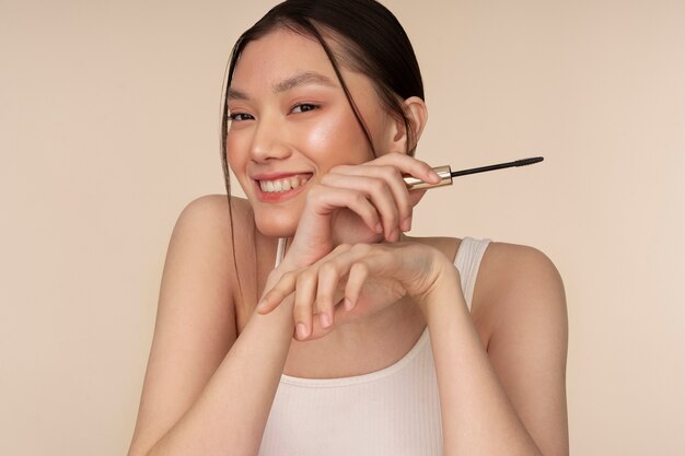 Free Photo front view korean woman posing with mascara