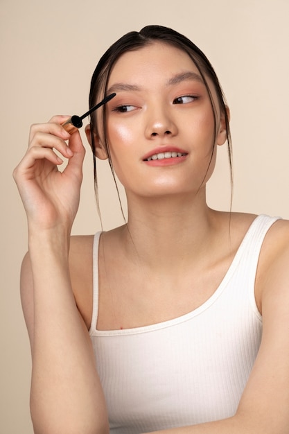 Front view korean woman posing with mascara