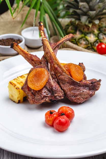 Free photo front view lamb ribs kebab with dried apricots and cherry tomatoes