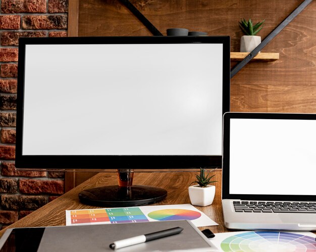 Front view of laptop and computer on office workspace