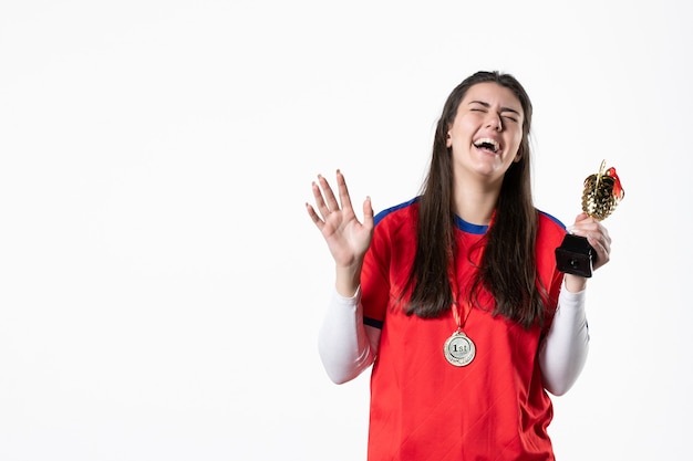 Front view laughing female player with golden cup and medal