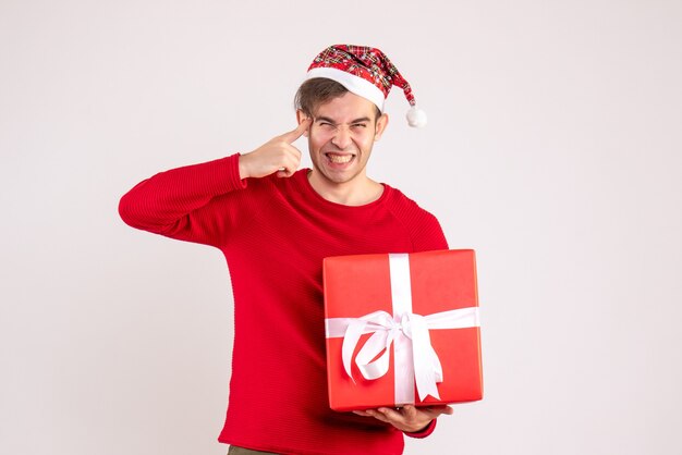 Front view laughing young man with santa hat standing on white 
