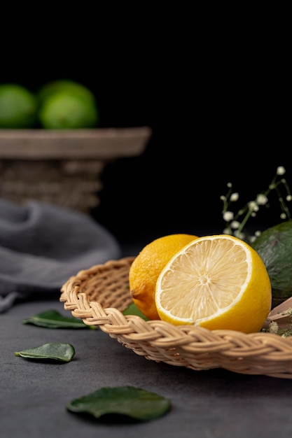 Front view of lemon half on plate with leaves