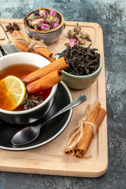 Front view lemon tea in cup and kettle on gray background color morning fruit breakfast ceremony photo food