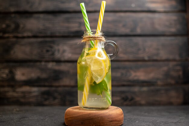 Front view lemonade yellow and green pipettes on wood board on wooden surface