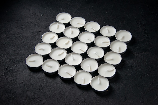 Free photo front view of light candles square shaped on black