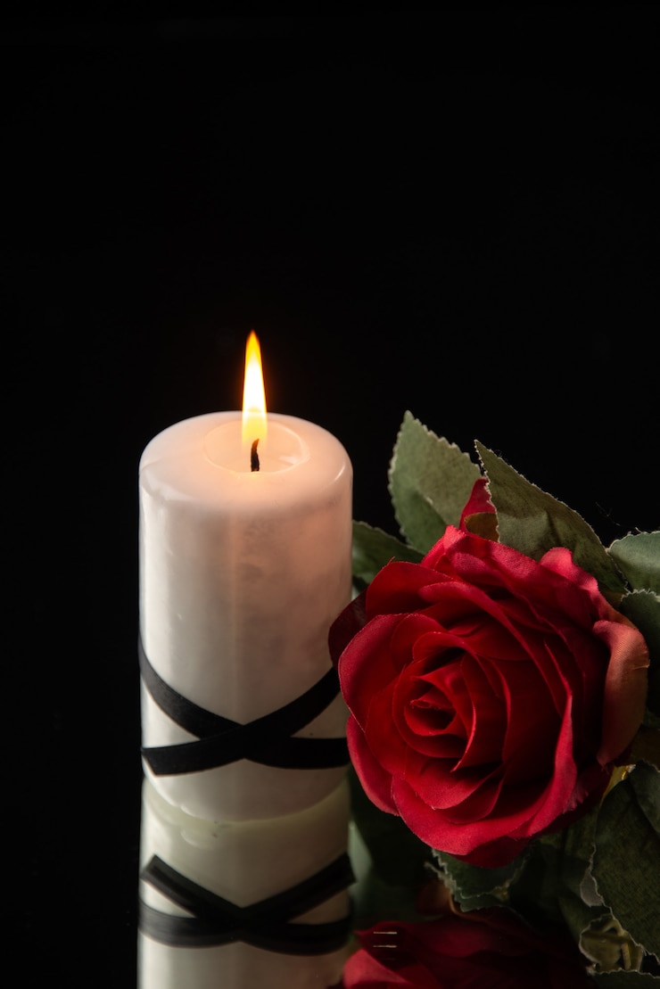 Free Photo front view of lighting candle with red flower on black