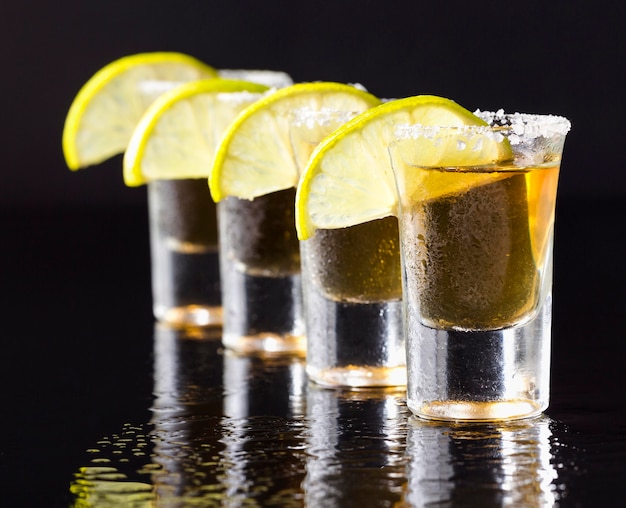 Front view line of gold tequila shots