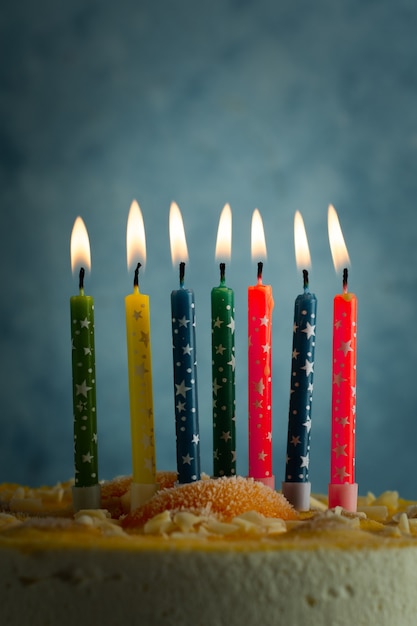 Free photo front view of lit multicolored birthday candles