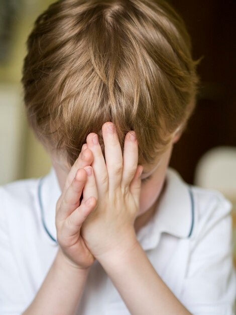 Front view of little boy praying