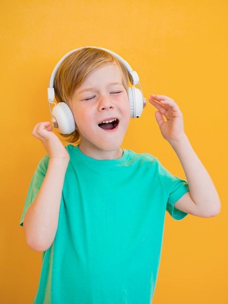 Free photo front view of little boy with music concept