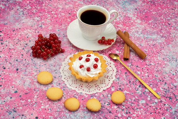 Вид спереди маленький торт со сливочным печеньем, свежая малина вместе с чашкой кофе на цветной поверхности печенья