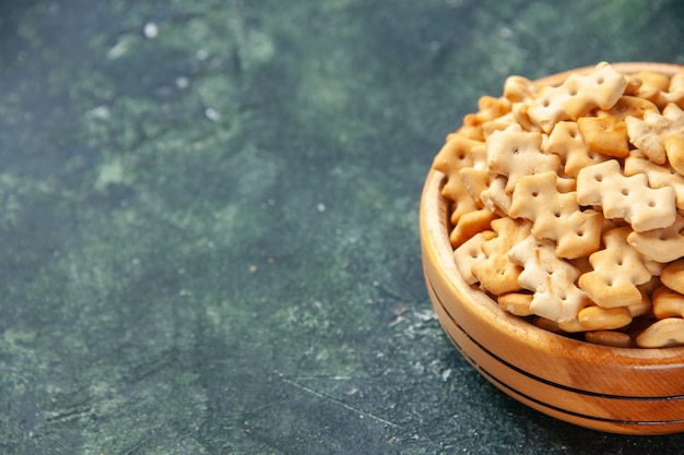 Front view little crackers inside plate on dark background crisp snack salt bread food cips color