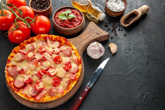 Front view little delicious pizza with fresh red tomatoes on dark salad food dough cake color photo fast-food delivery